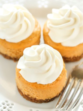 These Mini Pumpkin Cheesecakes feature an easy three ingredient gingersnap cookie crust with a smooth and creamy pumpkin cheesecake filling on top. These are the perfect mini dessert for fall!