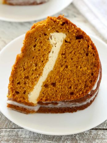 A slice of a pumpkin bundt cake on a white plate.